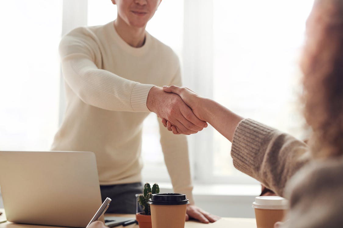 Professional real estate agent's hands hold an old-fashioned brass key and a modern digital tablet, symbolizing the evolut...