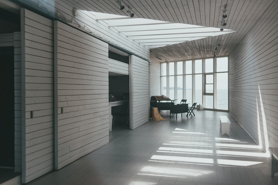 A minimalist architectural photo showing two different modern doors side-by-side, symbolizing the choice between a flat-fee and commission-split brokerage.