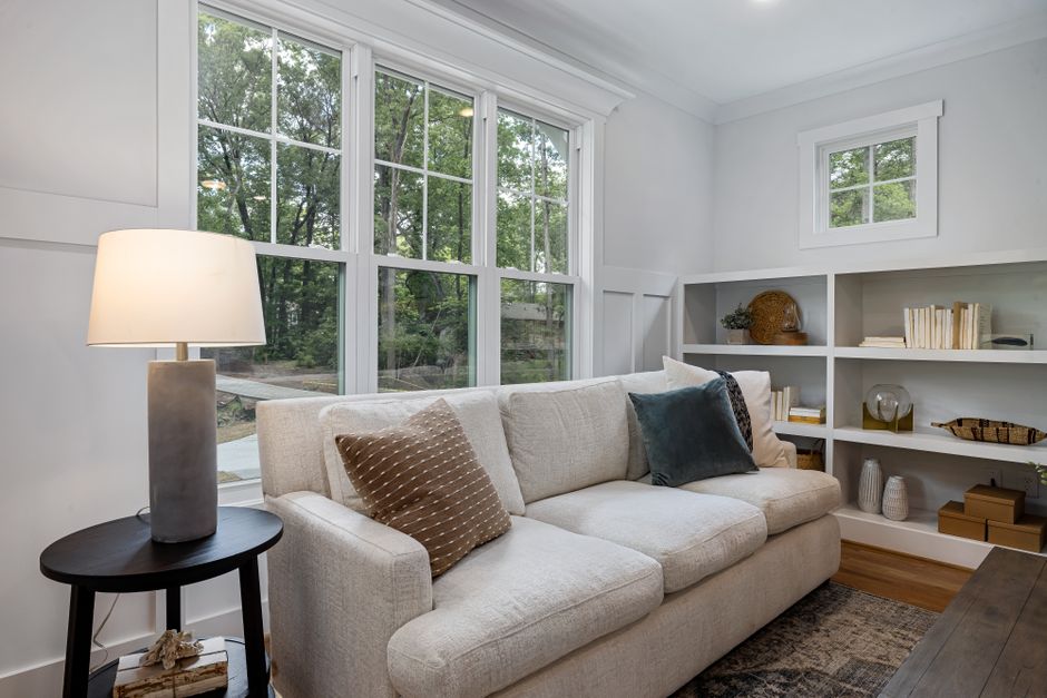 A bright, airy, and modern living room in a Southern-style home, representing the comfortable and energy-efficient result of proper insulation.